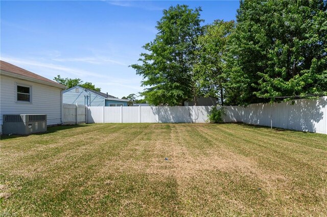view of yard with cooling unit and a fenced backyard