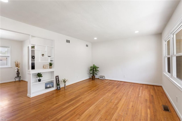 unfurnished room with visible vents, recessed lighting, and light wood finished floors