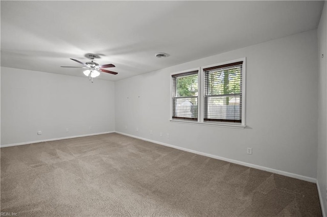 unfurnished room with baseboards, carpet, and a ceiling fan