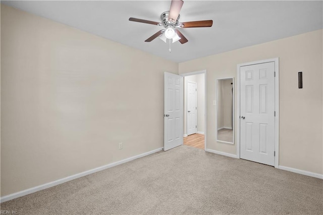 unfurnished bedroom with a ceiling fan, baseboards, and carpet