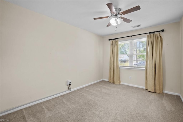 carpeted empty room with baseboards, ceiling fan, and visible vents