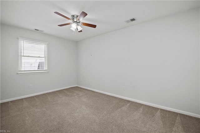 carpeted empty room featuring a ceiling fan, baseboards, and visible vents