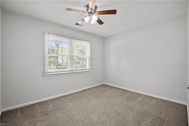 unfurnished room featuring carpet floors, a ceiling fan, baseboards, and visible vents