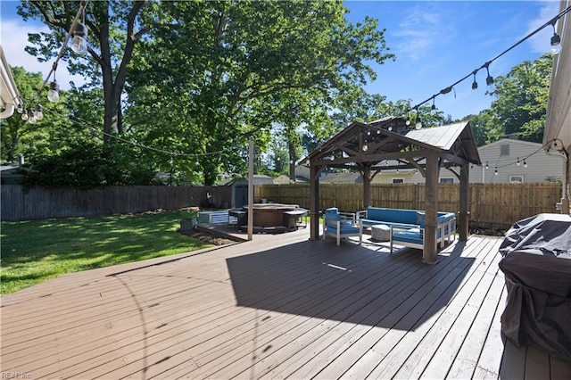 wooden terrace featuring a gazebo, an outdoor hangout area, a fenced backyard, a yard, and a jacuzzi