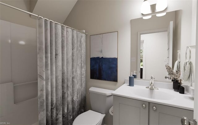 bathroom with vanity, curtained shower, and toilet
