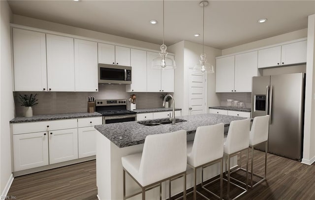 kitchen featuring backsplash, appliances with stainless steel finishes, a sink, dark wood-style floors, and recessed lighting