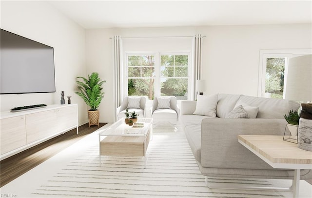 living room with plenty of natural light and wood finished floors