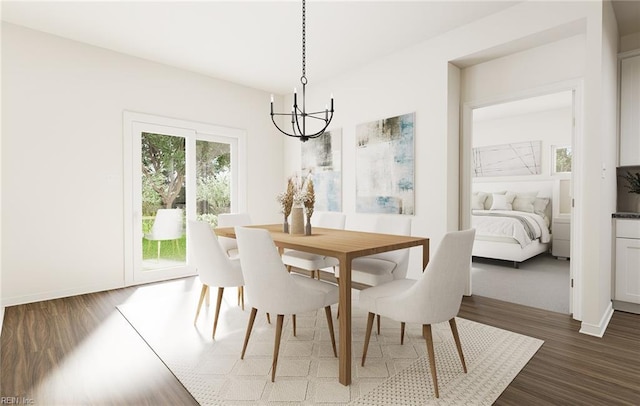 dining space featuring baseboards, an inviting chandelier, and dark wood-type flooring