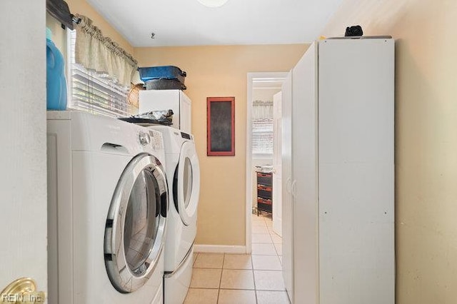 1609 Macgregory Ct, Virginia Beach, VA 23464 - laundry area featuring light tile patterned floors, baseboards, cabinet space, and washer and clothes dryer
