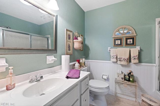 1609 Macgregory Ct, Virginia Beach, VA 23464 - bathroom with vanity, a shower with door, a wainscoted wall, and toilet