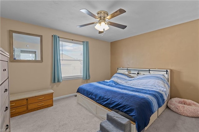 bedroom with ceiling fan, baseboards, and light carpet