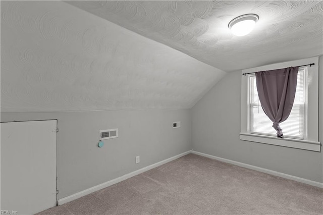 bonus room featuring baseboards, visible vents, carpet floors, and vaulted ceiling