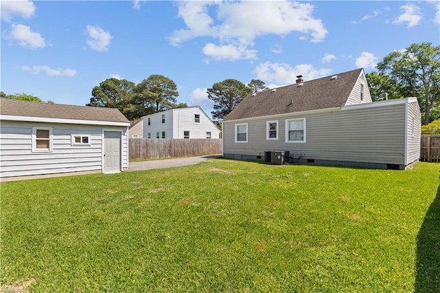 back of house with crawl space, fence, cooling unit, and a lawn