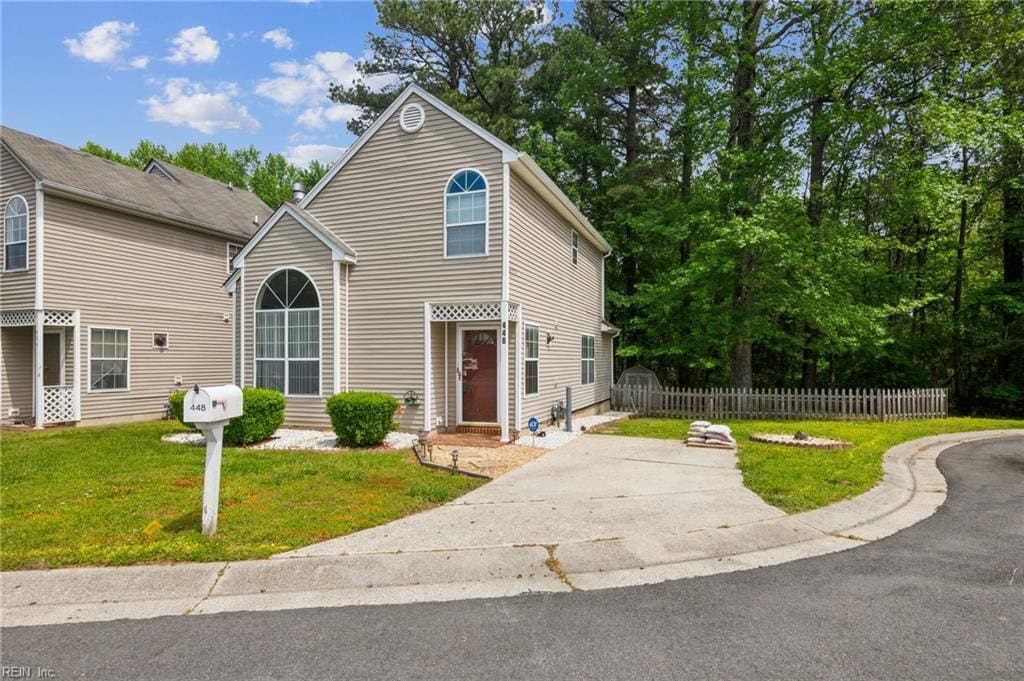 traditional-style home with fence and a front lawn