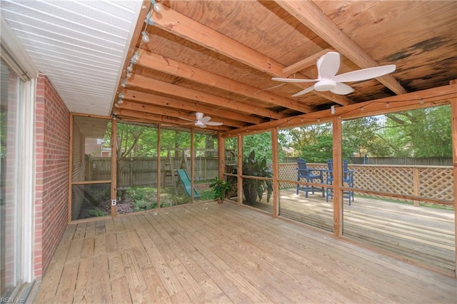 unfurnished sunroom with ceiling fan