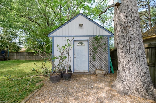 view of shed featuring fence