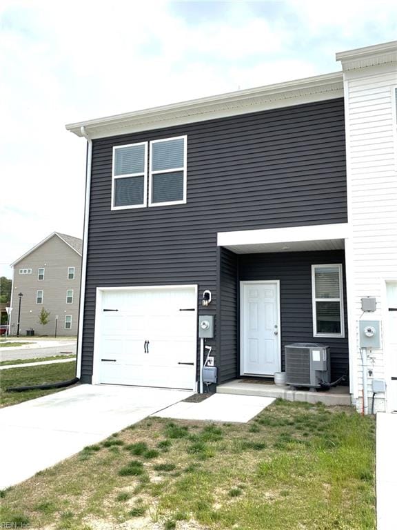 1547 Stanford Ln, Newport News, VA 23608 - view of front of home with an attached garage, cooling unit, and concrete driveway