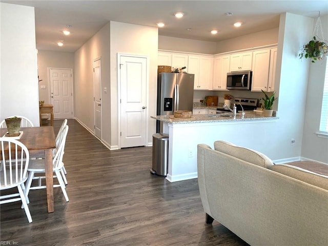 1547 Stanford Ln, Newport News, VA 23608 - kitchen featuring light stone counters, white cabinetry, appliances with stainless steel finishes, and dark wood-style flooring