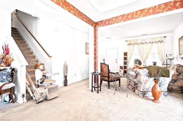 carpeted living room featuring stairway