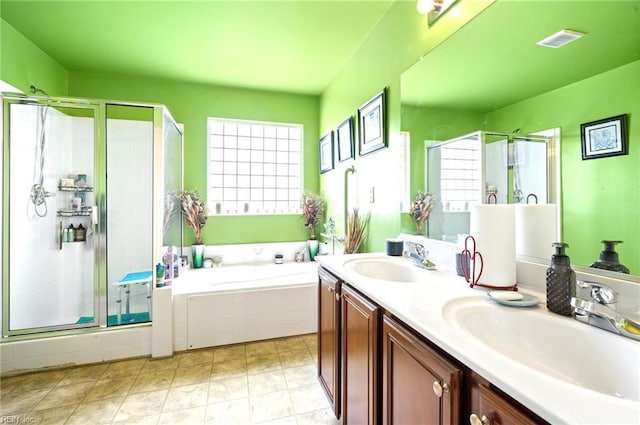 bathroom featuring a garden tub, visible vents, a sink, and a stall shower