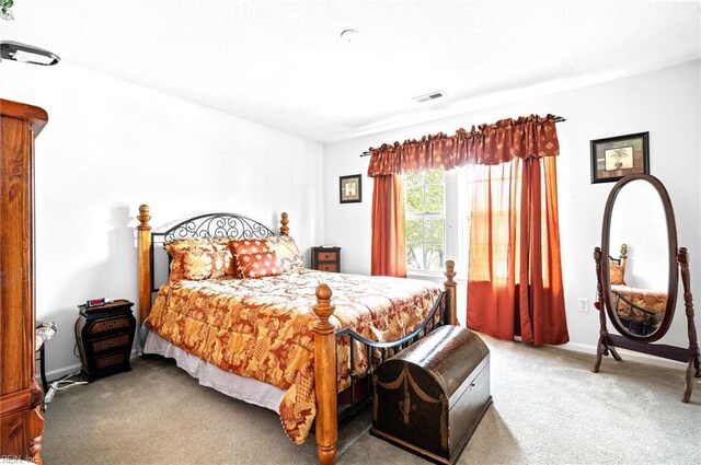 bedroom featuring carpet floors, visible vents, and baseboards