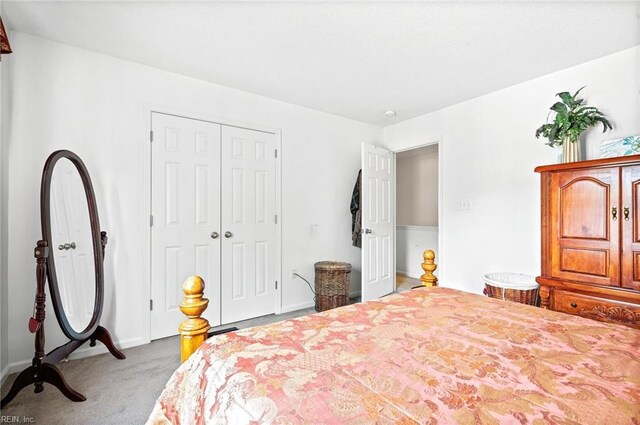 bedroom with carpet floors, a closet, and baseboards