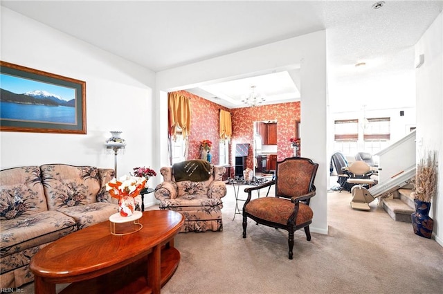 carpeted living room featuring stairway, baseboards, a chandelier, and plenty of natural light