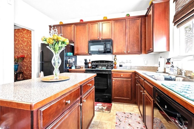 kitchen featuring black appliances, a sink, a kitchen island, and light countertops