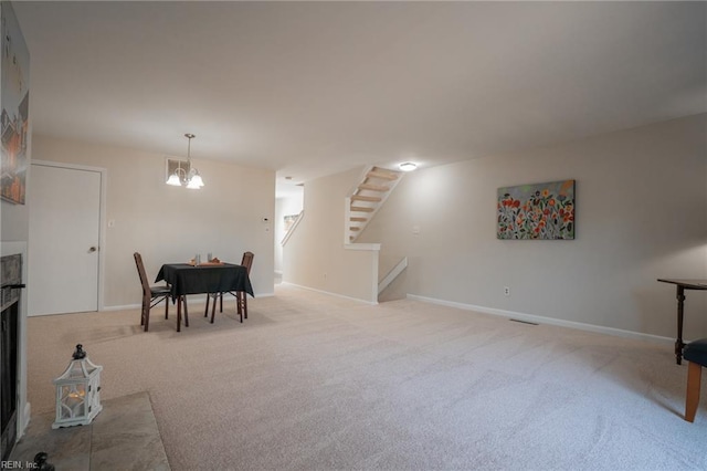 interior space featuring baseboards, a notable chandelier, and stairway
