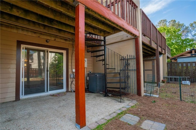 view of patio featuring stairs, central AC unit, and fence