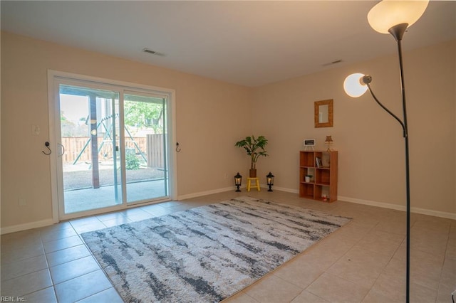 interior space featuring visible vents, tile patterned flooring, and baseboards