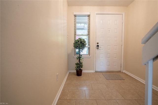 entrance foyer featuring light tile patterned flooring and baseboards