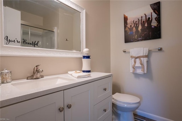 full bath featuring baseboards, an enclosed shower, toilet, and vanity