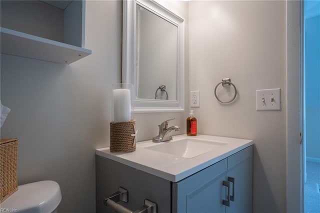 half bath featuring vanity and toilet