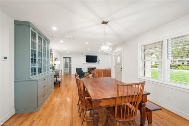dining space with light wood-style floors, visible vents, baseboards, recessed lighting, and a fireplace
