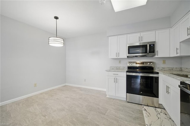 kitchen with light stone countertops, baseboards, hanging light fixtures, white cabinets, and appliances with stainless steel finishes