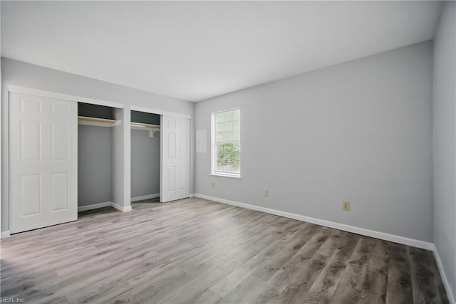 unfurnished bedroom featuring baseboards and wood finished floors