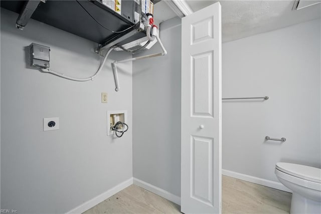 laundry area with electric dryer hookup, washer hookup, laundry area, and baseboards