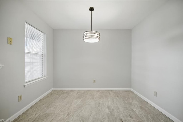 spare room with baseboards