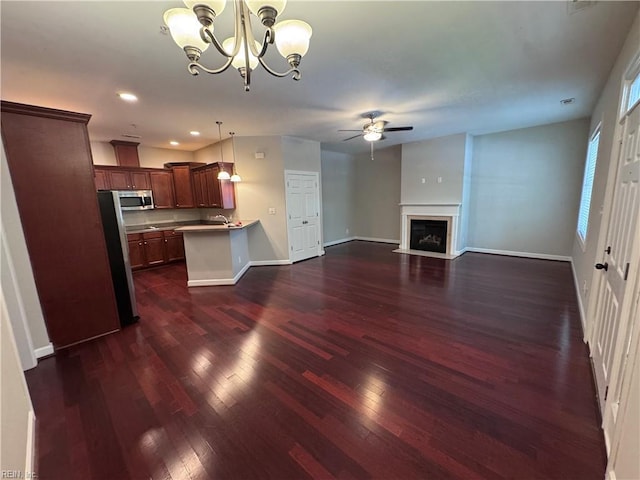 35 Miles Cary Mews, Hampton, VA 23669 - unfurnished living room featuring a fireplace with flush hearth, baseboards, recessed lighting, dark wood-type flooring, and ceiling fan with notable chandelier