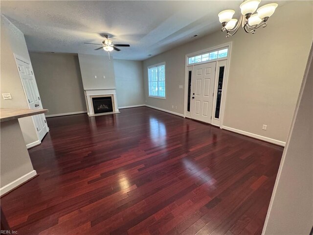 35 Miles Cary Mews, Hampton, VA 23669 - unfurnished living room featuring baseboards, wood finished floors, ceiling fan with notable chandelier, and a fireplace