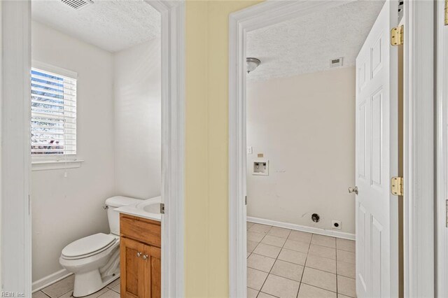 3605 Shell Rd, Hampton, VA 23661 - half bathroom featuring tile patterned floors, toilet, a textured ceiling, and vanity