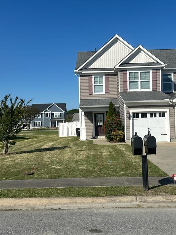 114 Spinnaker St Unit A, Elizabeth City, NC 27909 - view of front of home with a garage, driveway, a front lawn, and fence