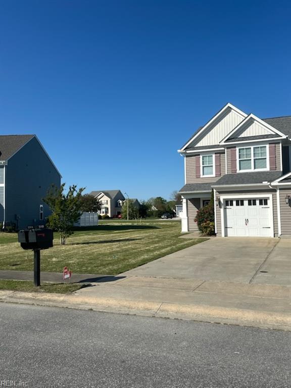 114 Spinnaker St Unit A, Elizabeth City, NC 27909 - view of front facade with board and batten siding, an attached garage, a front yard, and driveway