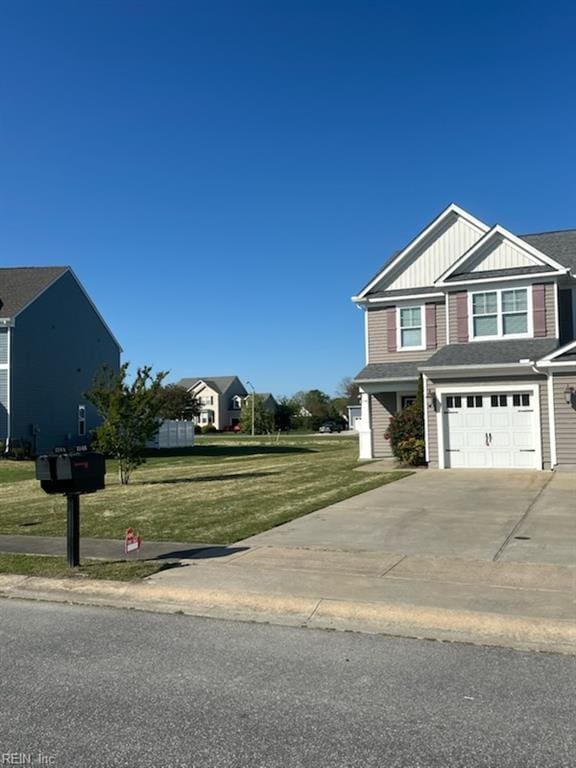 114 Spinnaker St Unit A, Elizabeth City, NC 27909 - view of front facade with board and batten siding, an attached garage, a front yard, and driveway