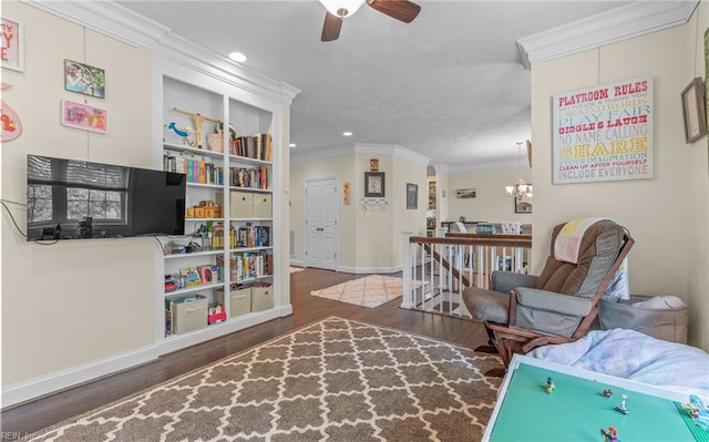 living area with ornamental molding, wood finished floors, an upstairs landing, and recessed lighting