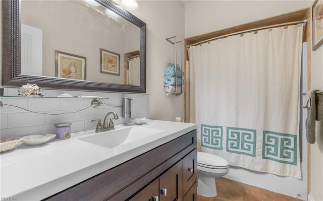 full bathroom featuring shower / bath combo, tasteful backsplash, toilet, and vanity
