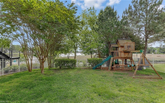 view of play area featuring a lawn and fence