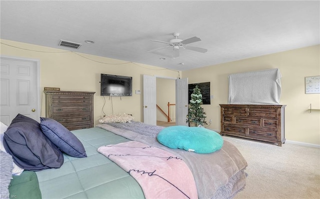 bedroom with baseboards, visible vents, ceiling fan, and carpet floors