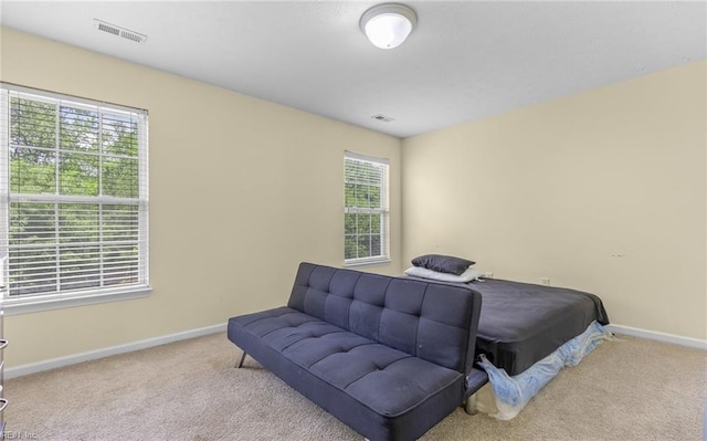 bedroom featuring baseboards, visible vents, and carpet floors